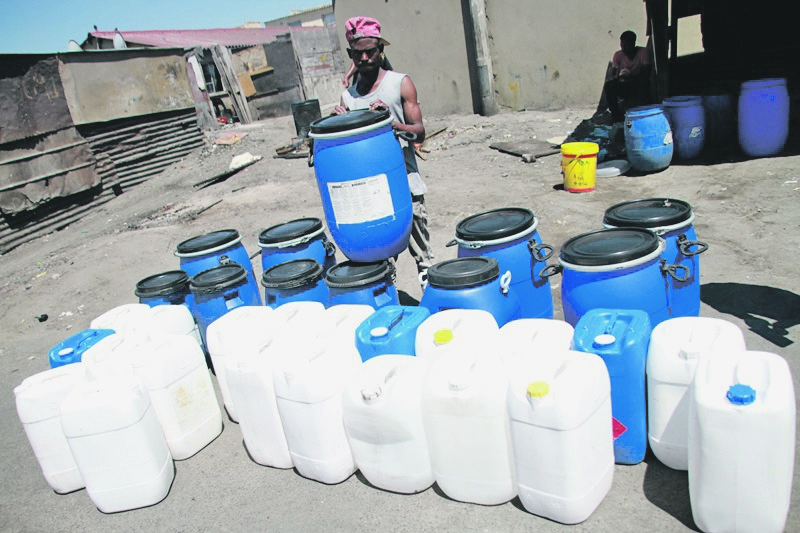 Sakhiwe Thengani from Nyanga sells these buckets, which have become scarce due to the water crisis.              Photo by Lindile Mbontsi