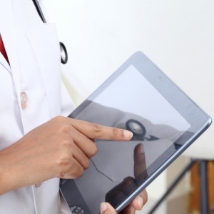 Doctor with tablet – iStock
