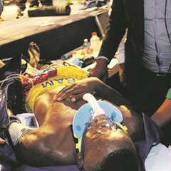 Sinethemba Bam gets medical attention after being knocked out by Lerato Dlamini during their IBF featherweight youth title fight. (Khothatso Mokone.)