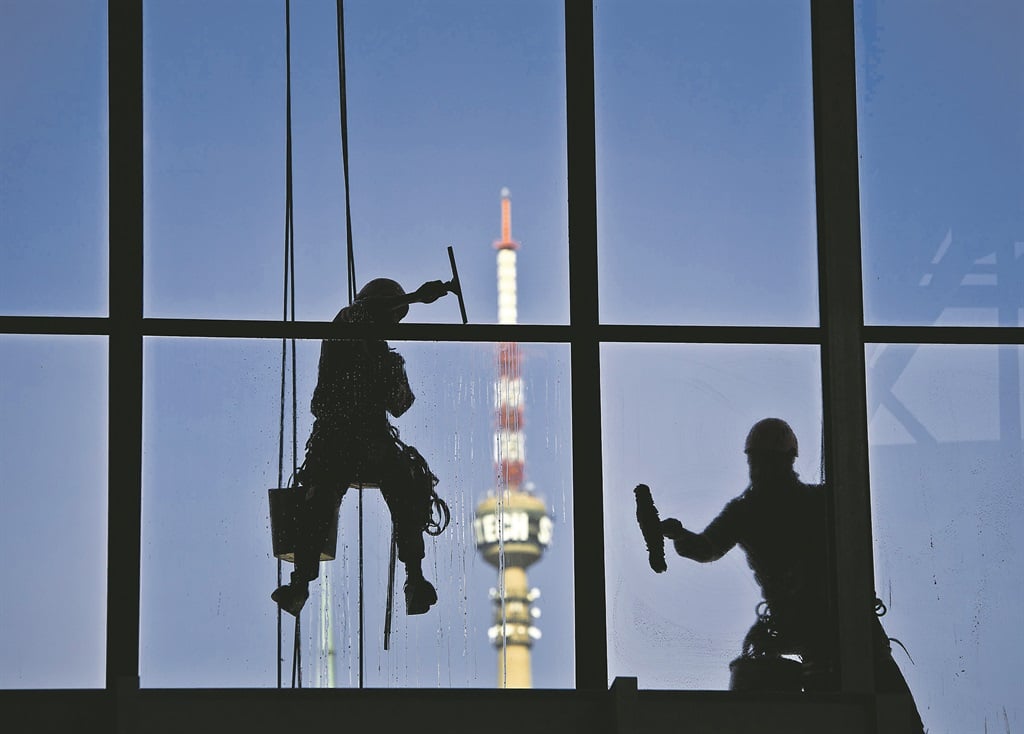 HANG IN THE BALANCE Window cleaners hang on ropes as they clean windows at Media Park in Johannesburg. Picture: Cornel van Heerden 