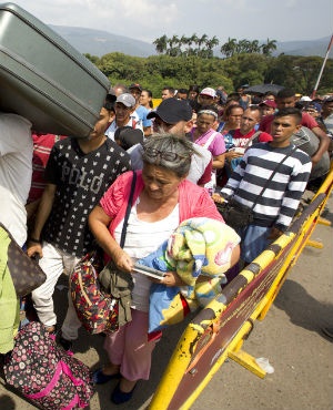 Venezuelan citizens cross the International Simon Bolivar bridge into the Colombia. (Fernando Vergara, AP, file)