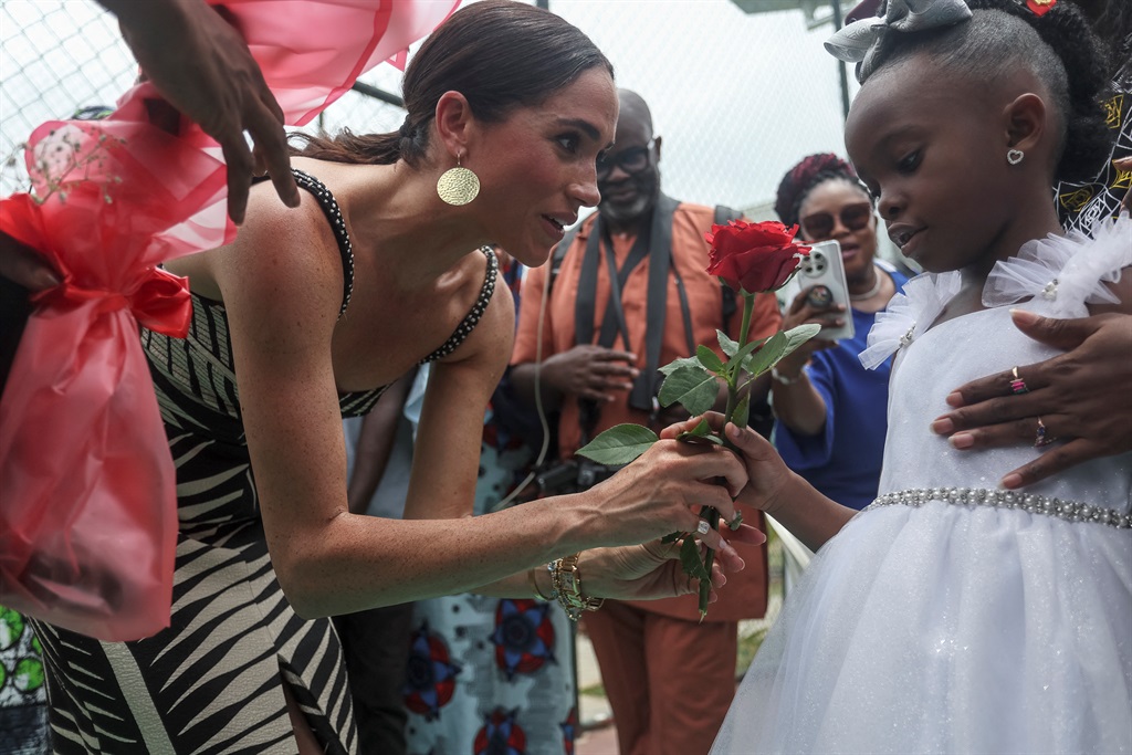 Britain's Meghan (C), Duchess of Sussex, receives 