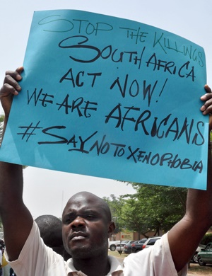 A demonstrator holds a banner during a rally called by the NGO Advocate for Peoples' Rights and Justice in front of the SA High Commission in Abuja to protest against anti-immigrant violence that erupted in Durban. (File, AFP)