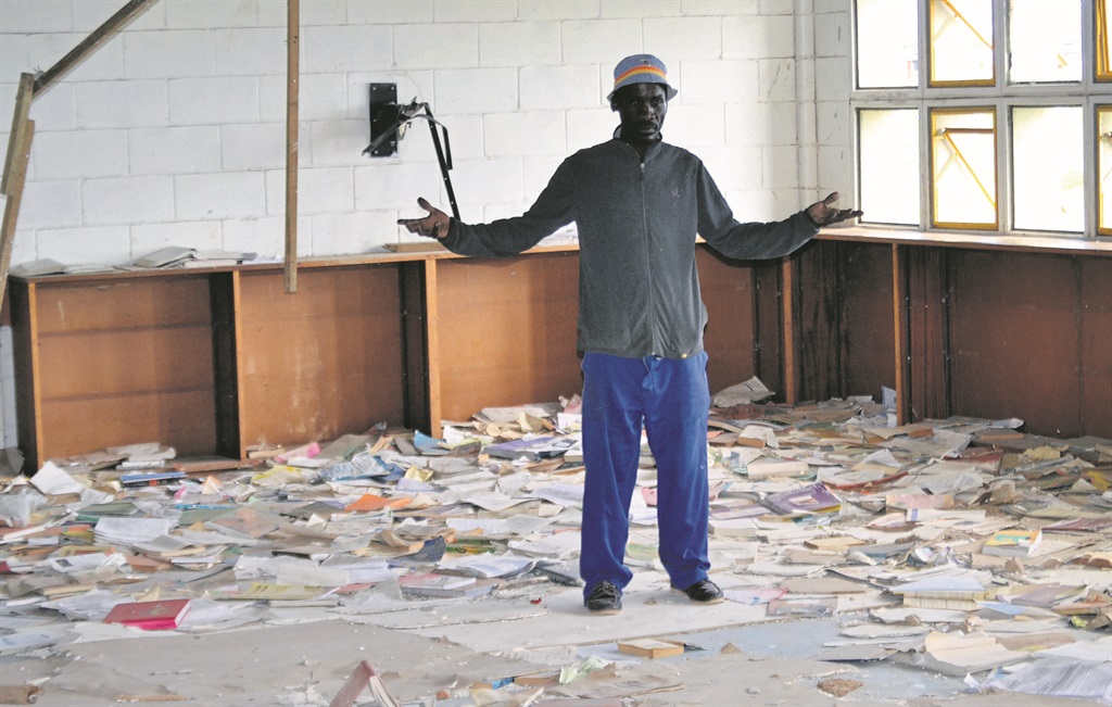 Caretaker Mzwakhe Klass inspects the damage to the library at Ncedo Senior Secondary School in Motherwell.                         Photo by Luvuyo Mehlwana 