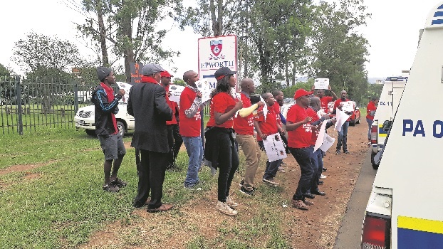 Members of the National Health Education and Allied Workers’ Union picketing outside Epworth School on Tuesday morning in support of dismissed permanent security guards. 