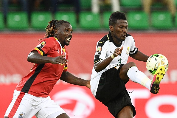 Ghana's forward Asamoah Gyan (R) challenges Uganda's midfielder Hassan Wasswa during the 2017 Africa Cup of Nations group D football match between Ghana and Uganda in Port-Gentil on January 17.