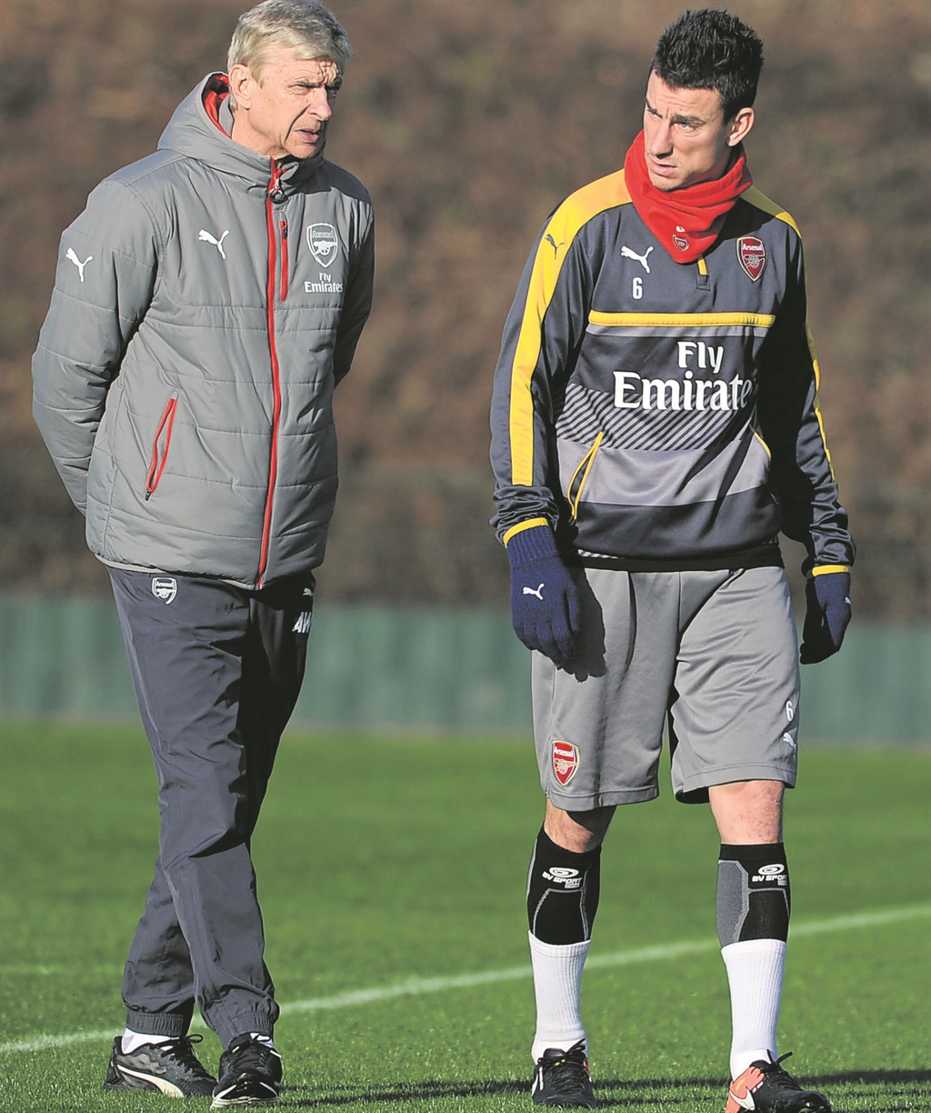 Arsene Wenger and defender Laurent Koscielny having a chat.  Photo by Getty Images 