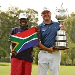 PATRIOTIC:  Thami Nkonyane displays a SA flag next to Graeme Storm, who won the SA Open Championship. (Luke Walker, Sunshine Tour, Gallo Images)