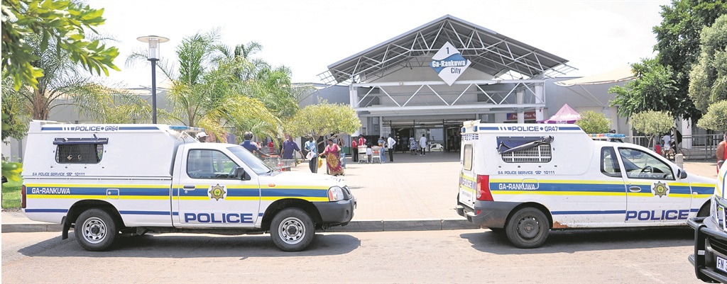 Police inspect the scene of the robbery in Ga-Rankuwa.       Photo by Samson Ratswana 