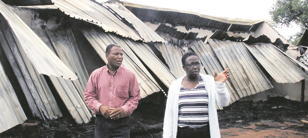 Pastor Denies Soares and college board member Sophie Chabalala inspect the damage caused by a mysterious fire at the college.     Photo by Armando Chikhudo 