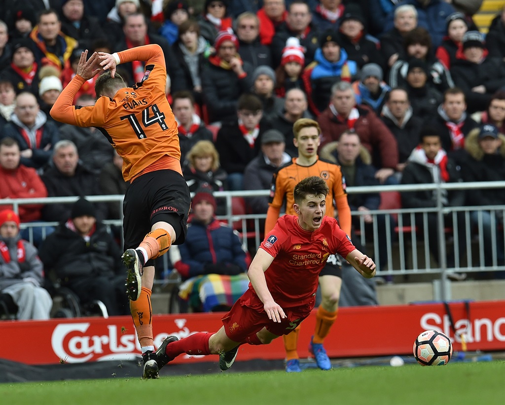 LAST CHANCE Ben Woodburn of Liverpool with Lee Evans of Wolves during the Emirates FA Cup fourth-round match between Liverpool and Wolverhampton Wanderers at Anfield on Sunday in Liverpool, England PHOTO: Andrew Powell/Liverpool FC/GETTY IMAGES 