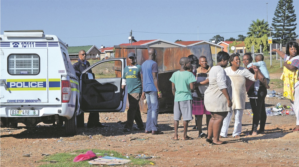 A cop at the scene in Motherwell where Anele Tshokela found a dead foetus in a rubbish bin.  Photo by Luvuyo Mehlwana 