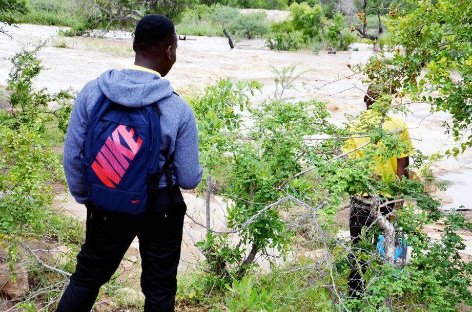 SAFE: Rescued boys Sibongiseni Khosa and Shaun Shobete on the banks of the swollen N'wandlamharhi River.