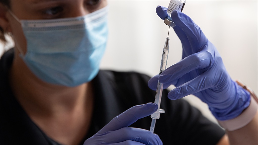 A health worker draws a Covid-19 vaccine.