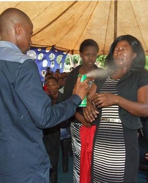 Pastor Lethabo Rabalago spraying the insecticide Doom on his congregants. (File, Facebook)