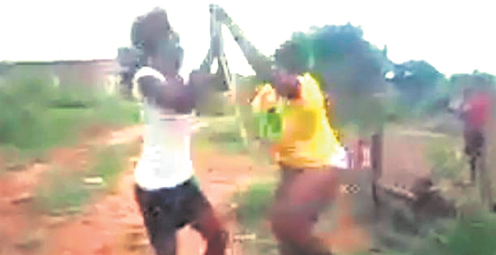 Screen shots from a video show Precious attacking a half-naked Thandeka with a stick after she had accused her of cheating with her boyfriend.  