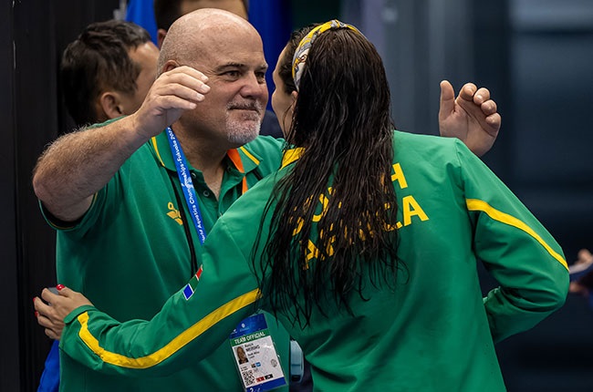 South African swimming coach Rocco Meiring embraces medallist Tatjana Schoenmaker. (Image by Anton Geyser/Gallo Images)