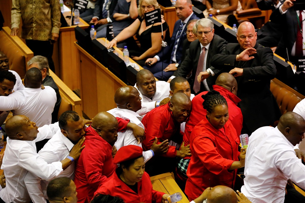 After almost an hour of disruptions and interruptions the “White Shirts” were ordered in to escort the EFF members out of the National Assembly. Before being man-handled Malema kept shouting “yes, kill me now!” to the security personnel. Picture: Sumaya Hisham/Reuters 