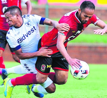 Bidvest Wits’ Daine Klate (left) and Al Ahly’s Walid Suleiman compete for the ball. Photo by Themba Makofane
