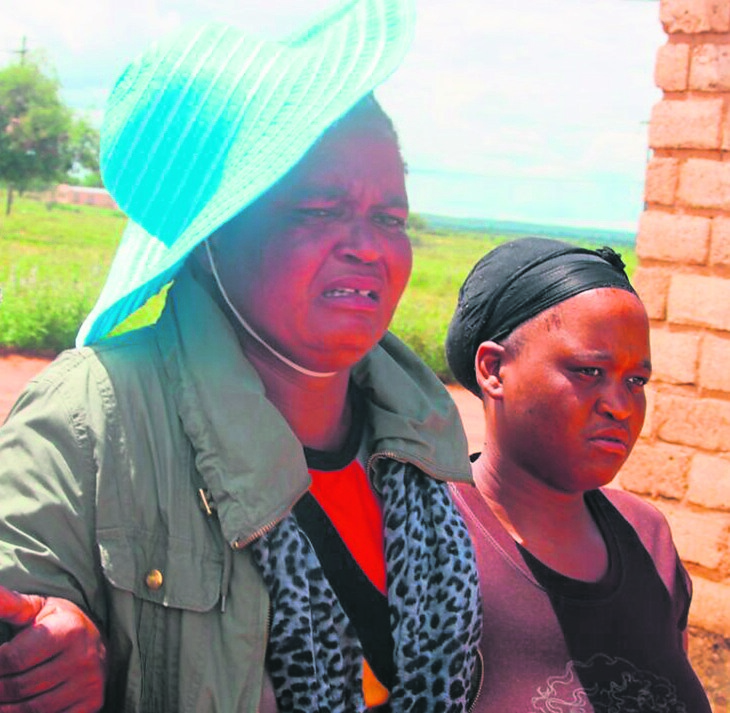 Family members mourn Hlompho Monchonyane, who was swept away by fast flowing water.   Photo by Thuso Sebotho
