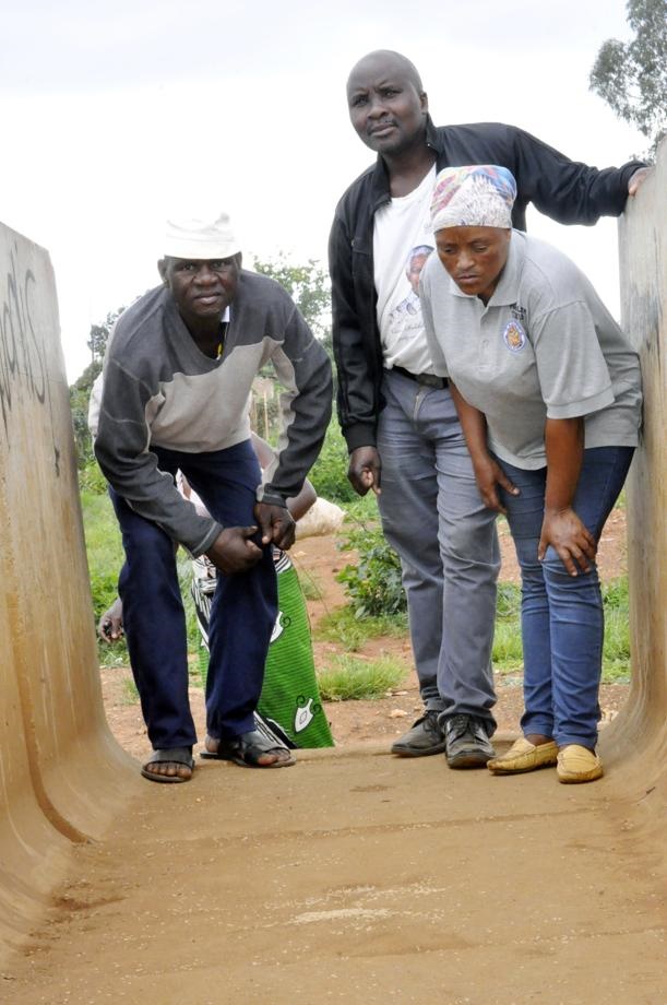 From left: Sthembiso Mjira, community leader Mjuli Skholiwe and Portia Makoto follow clues on the street. 
Photo by Sammy Moretsi