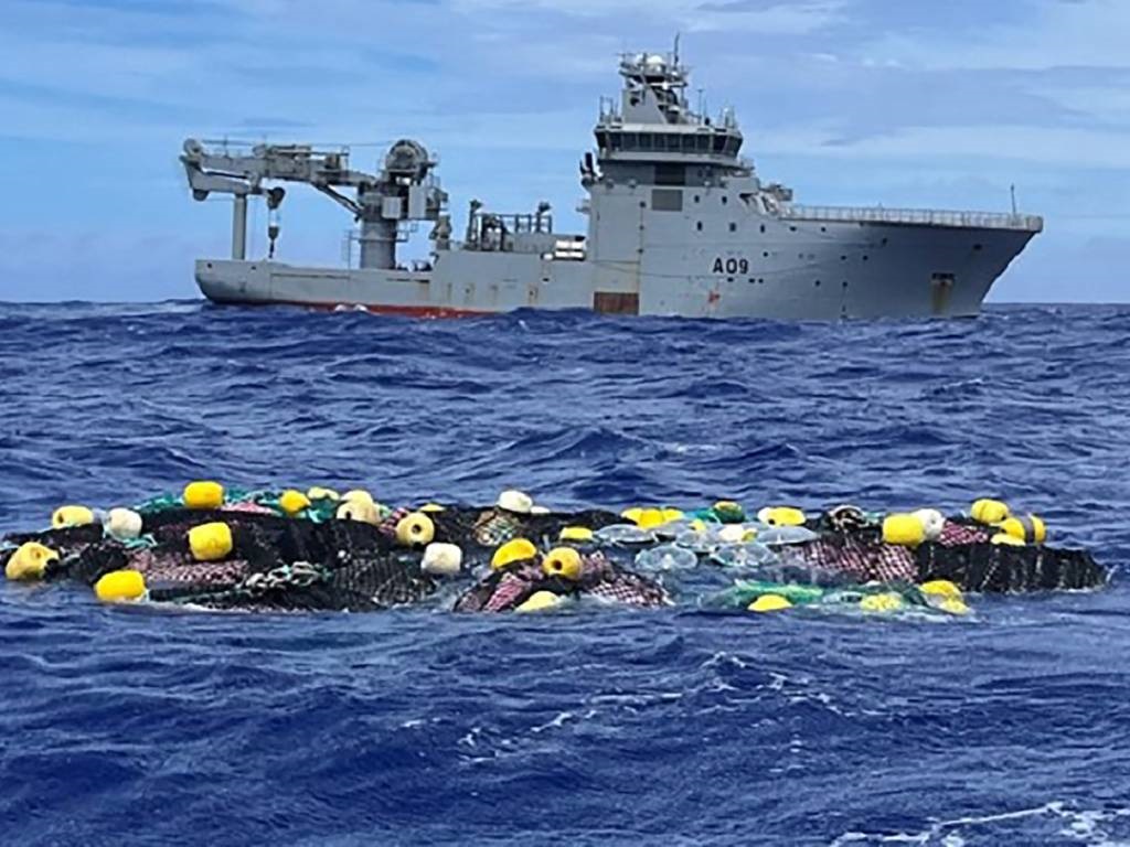 An undated handout photo received from the New Zealand Defence Force shows the Royal New Zealand Navy vessel HMNZS Manawanui retrieving 3.2 tons of cocaine adrift in the Pacific in a historic drug bust estimated to be worth around $316 million.