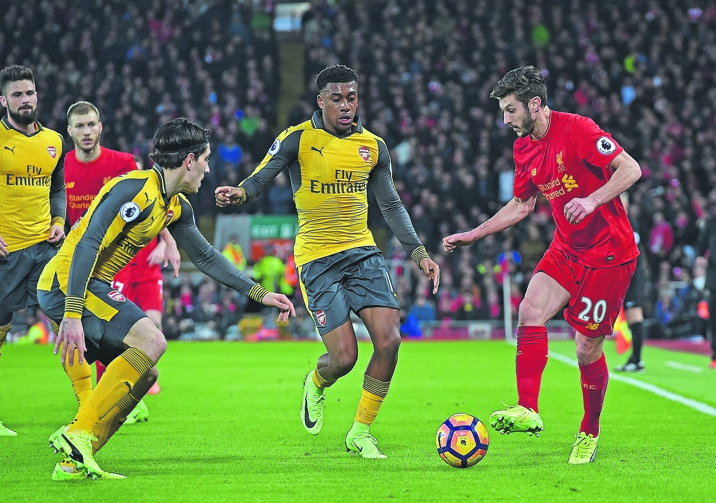 SLICE Adam Lallana of Liverpool (right) dribbles during the Premier League match against Arsenal at Anfield last night. Picture: Andrew Powell / Liverpool FC via Getty Image