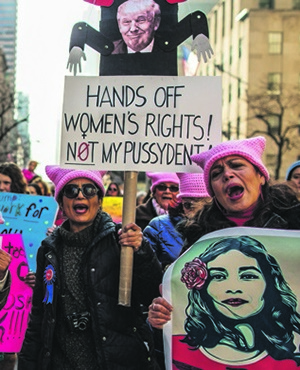 Demonstrators hold signs and chant during the Women’s March in New York City on January 21. Picture: Maite Mateo / VIEWpress / Corbis via Getty Images
