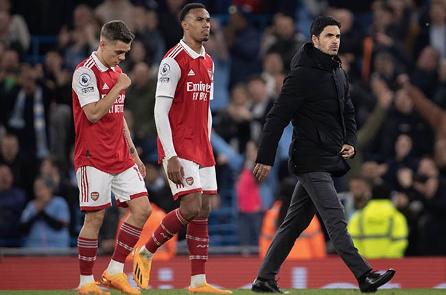 Mikel Arteta walks off the pitch looking dejected followed by Leandro Trossard and Gabriel Magalhaes of Arsenal. (Photo by Joe Prior/Visionhaus via Getty Images)
