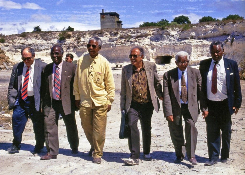 Memory lane: On February 11, 1994, the president and six of this fellow prisoners return to the lime quarry where they worked. From left: Dennis Goldberg, Andrew Mlangeni, Nelson Mandela, Ahmed Kathrada and Walter Sisulu, all fellow defendants at the Treason Trial. On the far right is Wilson Mkwayi, who was arrested after the Rivonia Trial and tried and convicted separately on similar charges. Picture: Jabu Kumalo