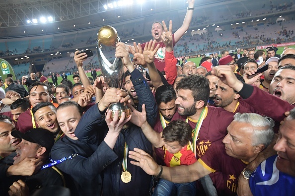 Esperance de Tunis players hold hold up the trophy after winning during the 2nd leg of CAF champion league final 2019 football match between Tunisias Esperance sportive de Tunis and Moroccos Wydad Athletic Club at the Olympic stadium 