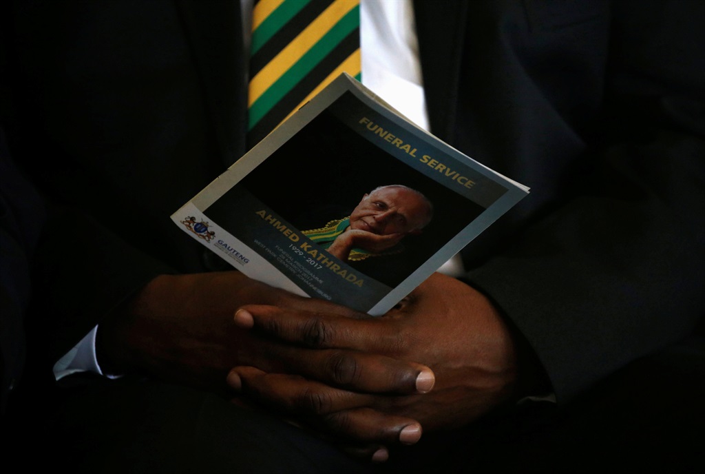 A mourner holds a programme bearing the face of Ahmed Kathrada during his funeral at Westpark Cemetery in Johannesburg on Wednesday, March 29 2017. Picture: Siphiwe Sibeko/Reuters