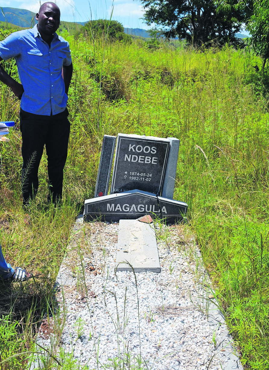 Sam Magagula stands next to his grandad’s grave. He died in 1982.      Photo by     Lolo Madonsela