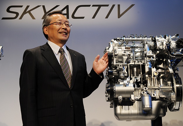 <i>Image: Mazda motors President Takashi Yamanouchi stands beside the company's SKYACTIV-D, next-generation clean diesel engine.</i>