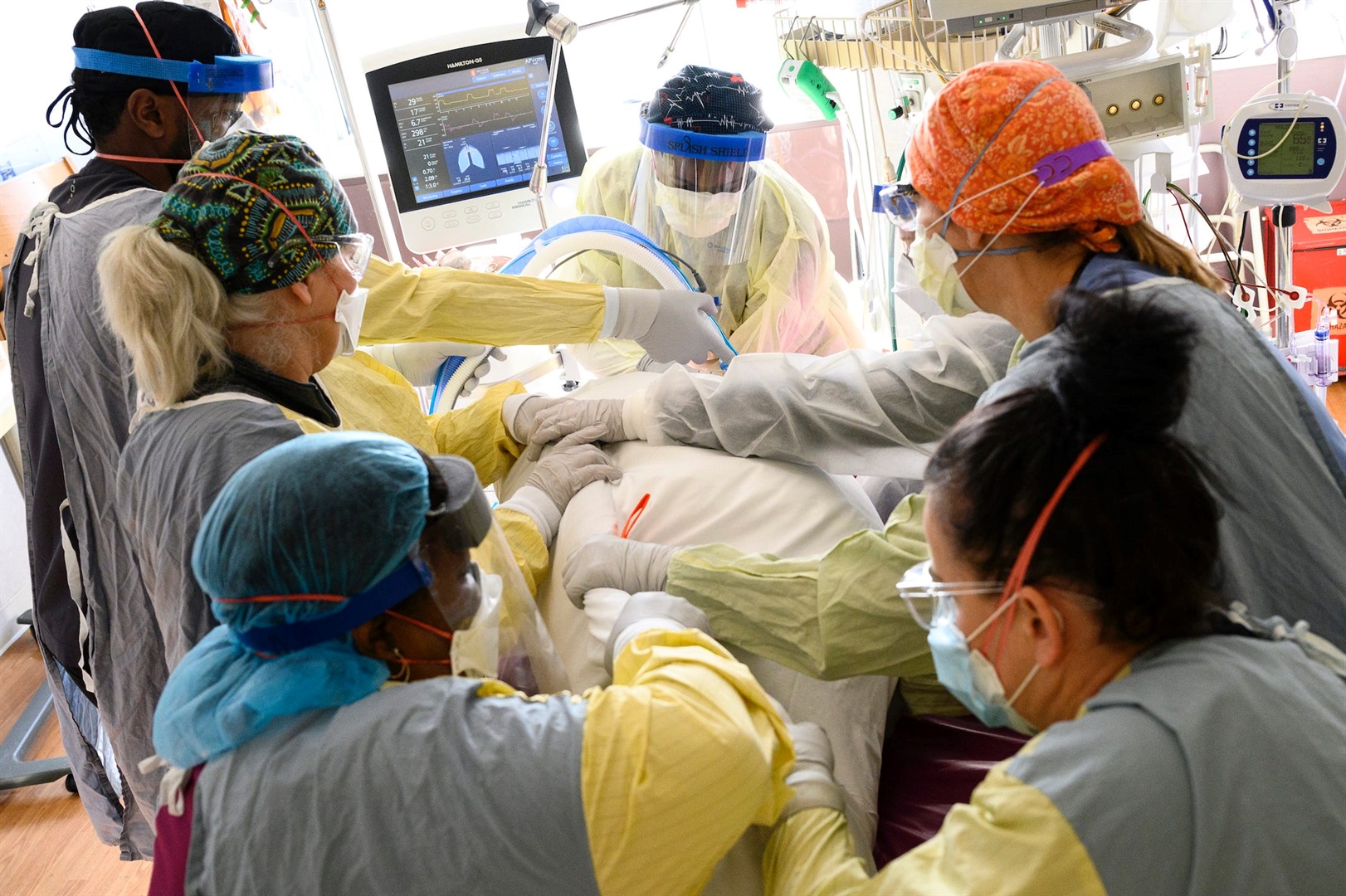A team of critical care nurses and assistants treat a critically-ill COVID-19 patient on December 8, 2021, at North Memorial Health Hospital in Robbinsdale, Minnesota.