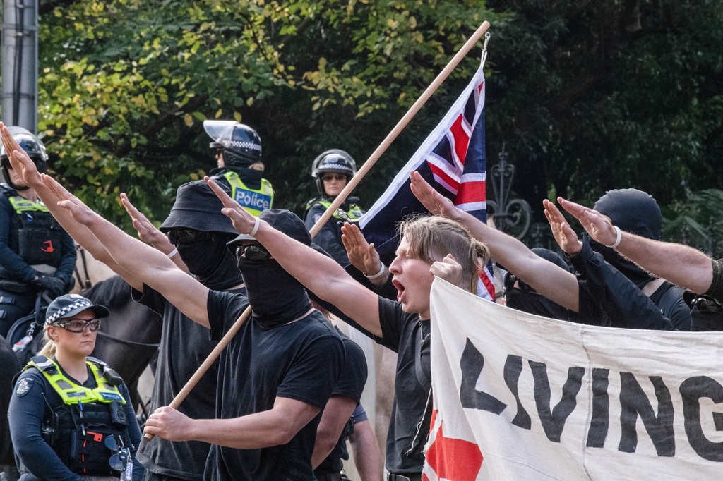Neo-Nazis perform the now-banned salute in Melbourne in May 2023, during an anti-immigration rally. (Photo by Michael Currie/SOPA Images/LightRocket via Getty Images)