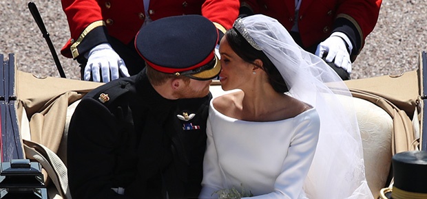 Prince Harry, Duke of Sussex and Meghan, the Duchess of Sussex kiss in the Ascot Landau Carriage. (Getty Images)