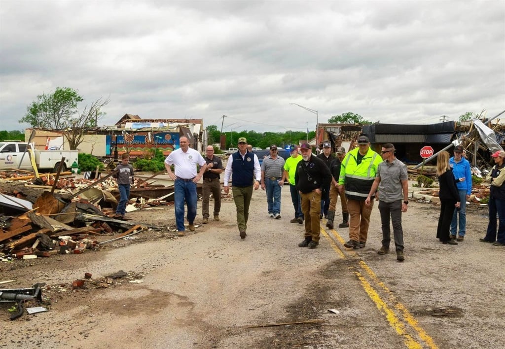 Oklahoma Governor Kevin Stitt examines the debris 