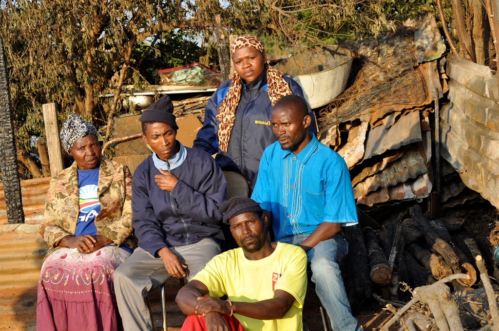 Neighbours, from left Junkey Mabina, Eddy Tshabeng, back Mina Sebitso, blue shirt, Nicholas Zwane and John Shivambo gathered in grief.Photo by Sammy Moretsi