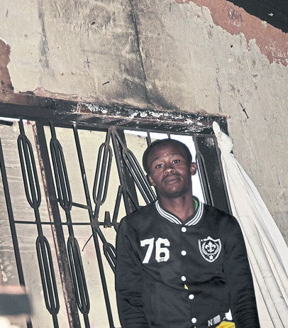 Thabiso Mahase says he will pray for answers after his RDP in Simunye was ruined by fire.  Photo by Sammy Moretsi