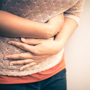 Woman with sore stomach
