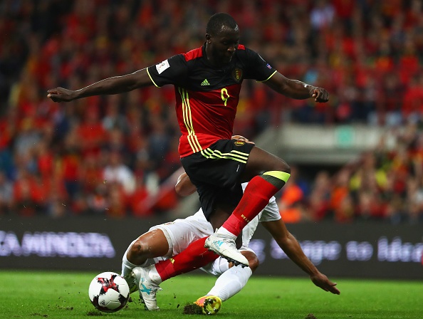 Romelu Lukaku of Belgium is tackled by Jason Pusey of Gibraltar during the FIFA 2018 World Cup Qualifier