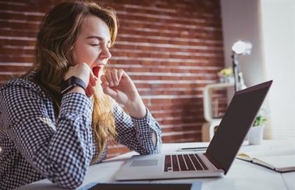 tired woman at her desk 