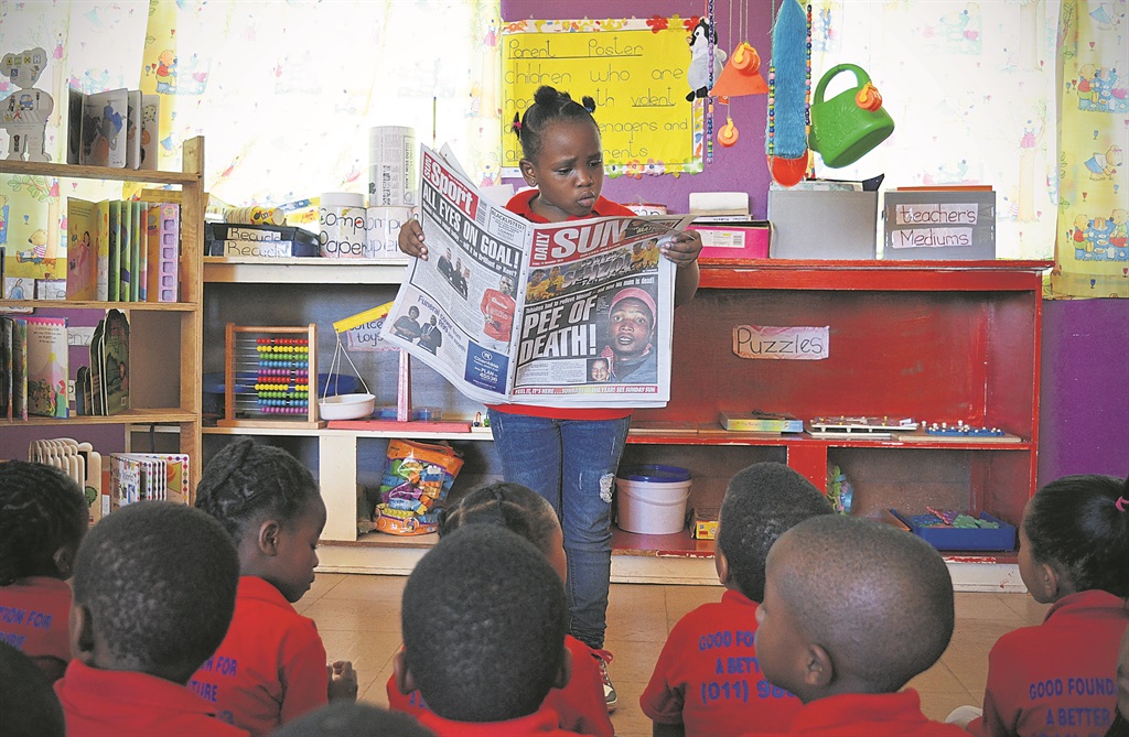 The youngest Daily Sun reader, Nompumelelo Zakwe reading the Daily Sun newspaper to her peers.                       Photo by Christopher Moagi