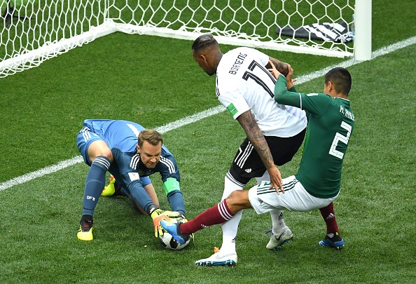 Manuel Neuer of Germany makes a save from Hugo Ayala of Mexico, as Jerome Boateng of Germany protects the ball during the 2018 FIFA World Cup