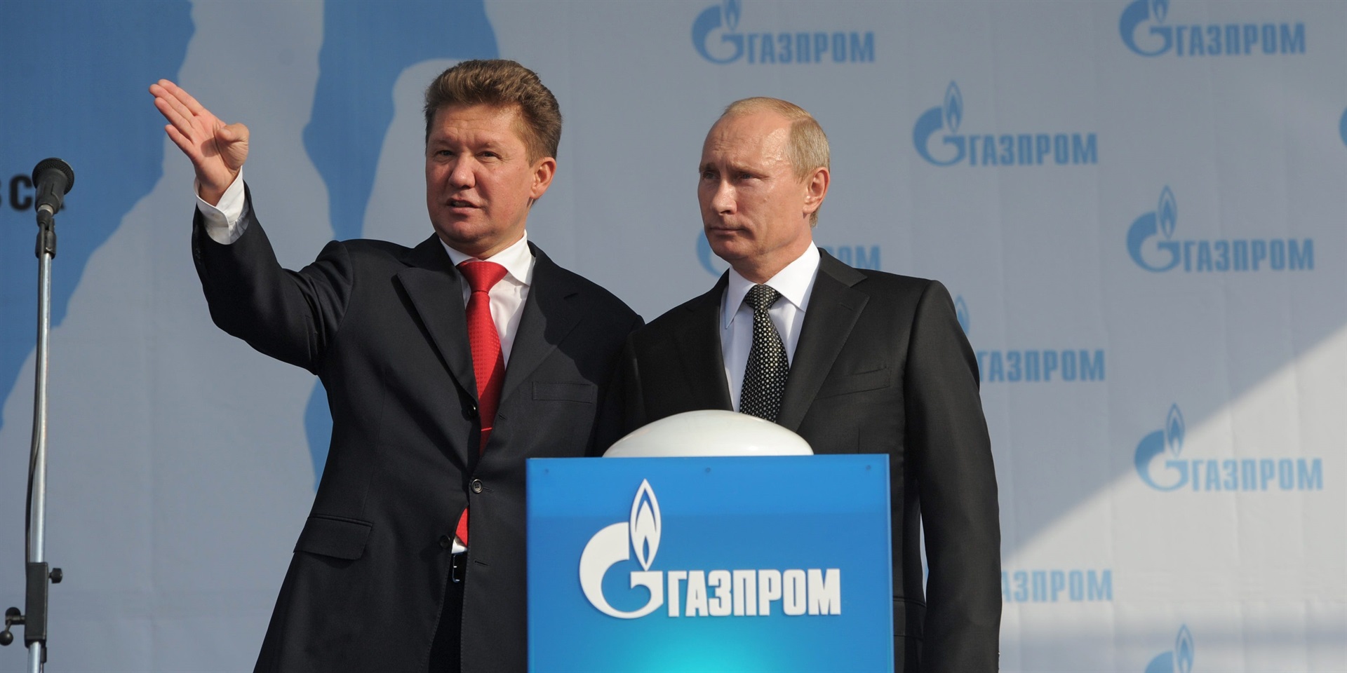 Gazprom CEO Alexey Miller stands next to Russian President Vladimir Putin.
