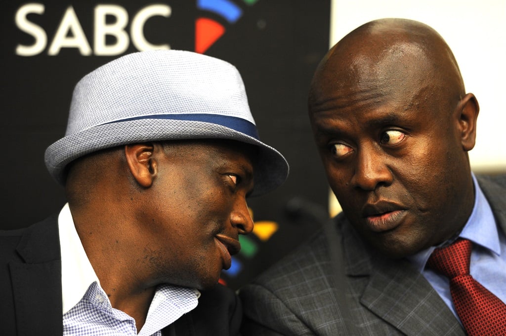 Hlaudi Motsoeneng, left, shares a moment with James Aguma at a media briefing when they were both still in power at the SABC.Picture: Felix Dlangamandla