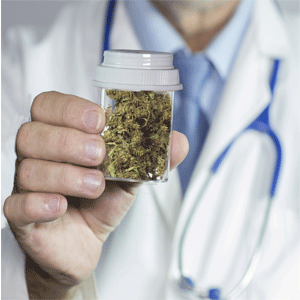 Close up of doctor holding up medical marijuana