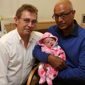 Baby Miane with father and doctor