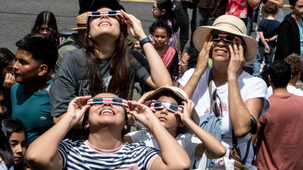 People watch the annular eclipse of the sun at the